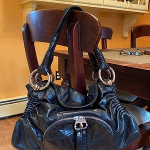 Black leather bag with metal accents